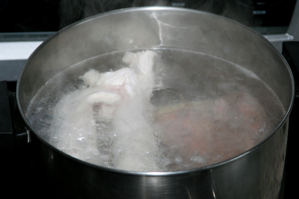 Blanching the brisket and tendon in big pot of boiling hot water